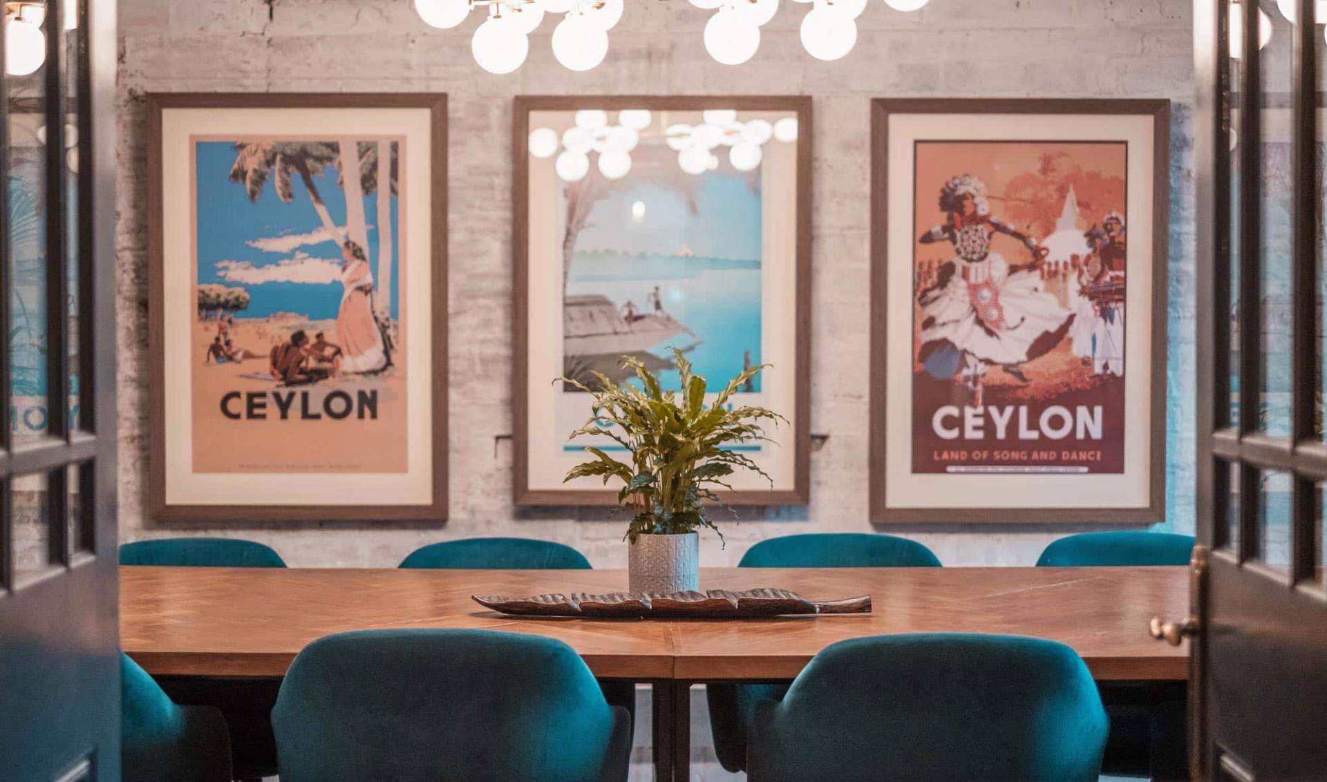 Manchester Meeting room with blue chairs and wooden table.